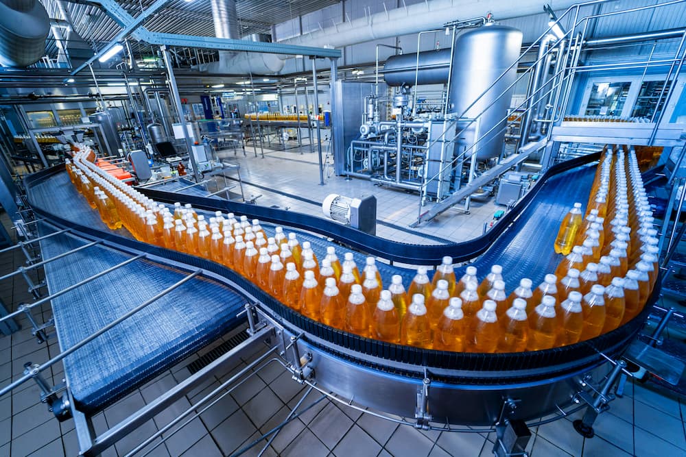 Oil packaging factory with an automated production line, showing bottles on a conveyor belt