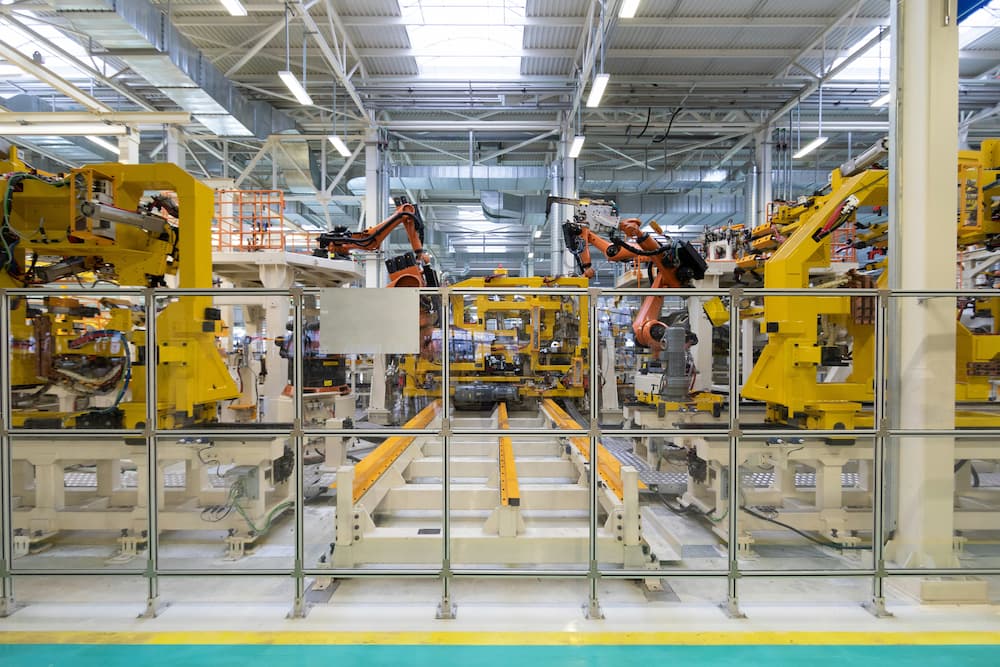 Factory with industrial robots in action, automating assembly and production processes