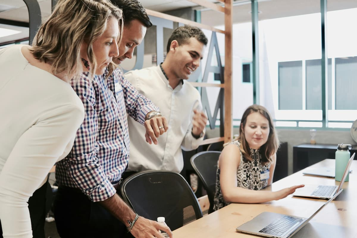 Team collaborating in an office environment, demonstrating interaction and group work