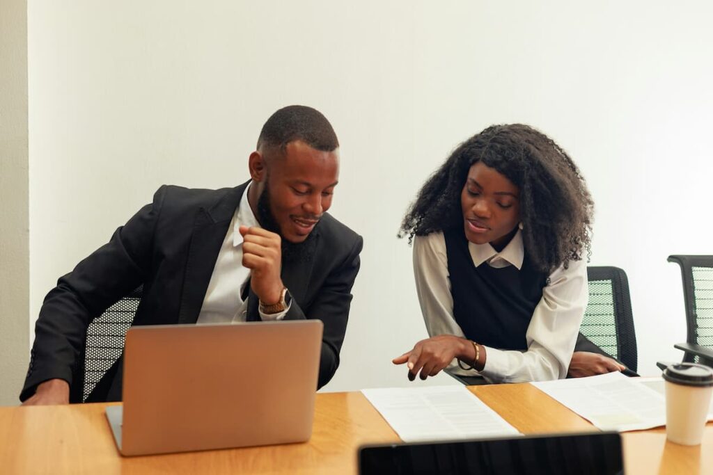 Two colleagues review legal documents together at a desk, illustrating efficient Legal Workflow Automation in practice.