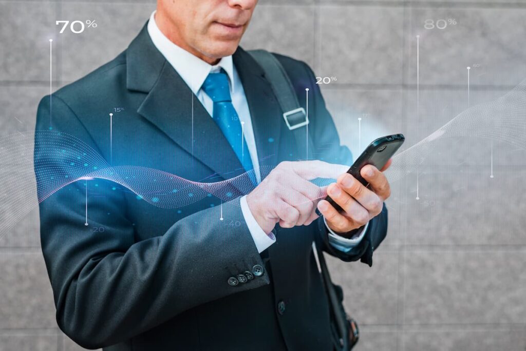 Businessman using smartphone with data overlay, showing how to visualize predictive analytics results in real time.
