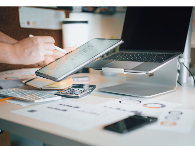 The image shows a modern and dynamic workspace setup focused on digital productivity and financial analysis.